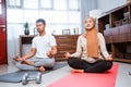 muslim beautiful woman and husband doing sit up together