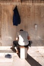 Muslim believer doing ablution process which is washing hands, mouth, nostrils, arms, head and feet with water Wudu