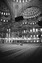 Muslim believer praying inside a mosque, black and white photo, grain film added