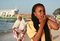 Muslim black girl walking on the beach near the port of Zanzibar Royalty Free Stock Photo