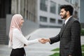 Muslim business partners shaking hands on street Royalty Free Stock Photo