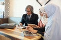 Muslim business people having meeting with businesswoman using laptop computer and tablet Royalty Free Stock Photo