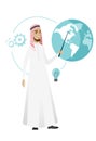 Muslim businessman pointing at a globe. Royalty Free Stock Photo