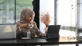 A muslim businesswoman in hijab sitting at her desk working on a laptop computer and drinking coffee. Royalty Free Stock Photo