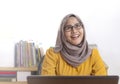 Muslim Businesswoman Working on Laptop at the Office, Thinking Gesture Royalty Free Stock Photo