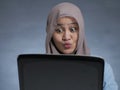 Muslim Businesswoman Working on Laptop Shocked Stunned Excited Gesture Royalty Free Stock Photo