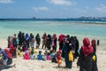Muslim children playing at the beach together with their parents