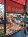 Muslim Chinese from Hui ethnic cooking stacks of meat skewers on Beiyuanmen Moslem Street