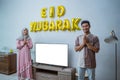 muslim couple with greeting gesture celebrating idul fitri