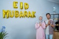 muslim couple with greeting gesture celebrating idul fitri