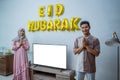 muslim couple with greeting gesture celebrating idul fitri