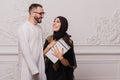 Muslim couple, a man makes a gift to his woman. Surprise from husband to wife