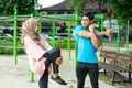 Muslim couples chatting while standing doing warm-up movements Royalty Free Stock Photo