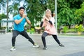 muslim couples in gym clothes doing the leg warm-up movement together before exercising