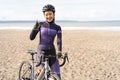 muslim cyclist with hijab showing thumb up while riding Royalty Free Stock Photo