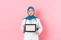 Muslim doctor carrying mobile digital tablet