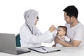 Muslim doctor checking a baby girl