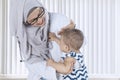 Muslim doctor examining temperature her patient Royalty Free Stock Photo