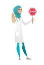 Muslim doctor holding stop road sign.