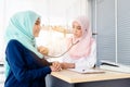Muslim doctor using stethoscope listen heartbeat