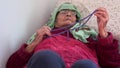 Muslim elderly woman praying on her bed in her room