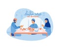 Muslim families gathered together at the dinner table. Eating together during Eid al Fitr.