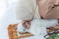 an Asian mother kissing cheek her 1-m -old baby newborn girl, is half Thai-half Nigerian Royalty Free Stock Photo