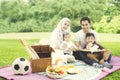 Muslim family with a book in the park Royalty Free Stock Photo