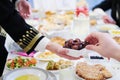 Muslim family having Iftar dinner eating dates to break feast Royalty Free Stock Photo