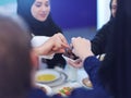 Muslim family having Iftar dinner eating dates to break feast Royalty Free Stock Photo