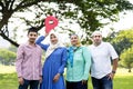 Muslim family holding up a check point symbol