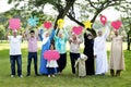 Muslim family holding up various social media icons Royalty Free Stock Photo