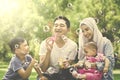 Muslim family playing with soap bubble Royalty Free Stock Photo