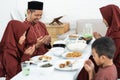 Muslim family pray when breaking fast Royalty Free Stock Photo