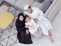 Muslim family reading Quran and praying at home
