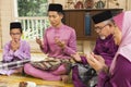 Muslim family saying prayers before meals