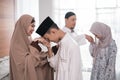 Muslim family shake hand apologizing during the Eid mubarak