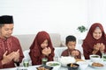 Muslim family pray when breaking fast Royalty Free Stock Photo