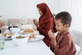 Muslim family pray when breaking fast Royalty Free Stock Photo