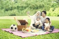 Muslim family with smartphone in the park Royalty Free Stock Photo