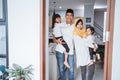 muslim family standing in front of their front door house welcoming guest at home Royalty Free Stock Photo