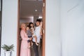 muslim family standing in front of their front door house welcoming guest at home Royalty Free Stock Photo