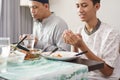 Muslim family together pray before meals Royalty Free Stock Photo