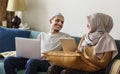 Muslim family using digital devices at home Royalty Free Stock Photo