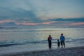 Muslim family walking along the beach in the sunset Royalty Free Stock Photo