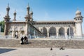 A Muslim family walking out from the Makkah Masjid mosque against blue sky, a famous monument in Hyderabad