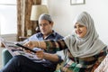 Muslim family watching tv at home Royalty Free Stock Photo