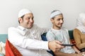 Muslim family watching tv at home Royalty Free Stock Photo