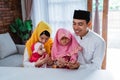 Muslim father,mother and daughter praying together Royalty Free Stock Photo