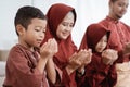 Muslim father,mother,daughter and son praying together Royalty Free Stock Photo